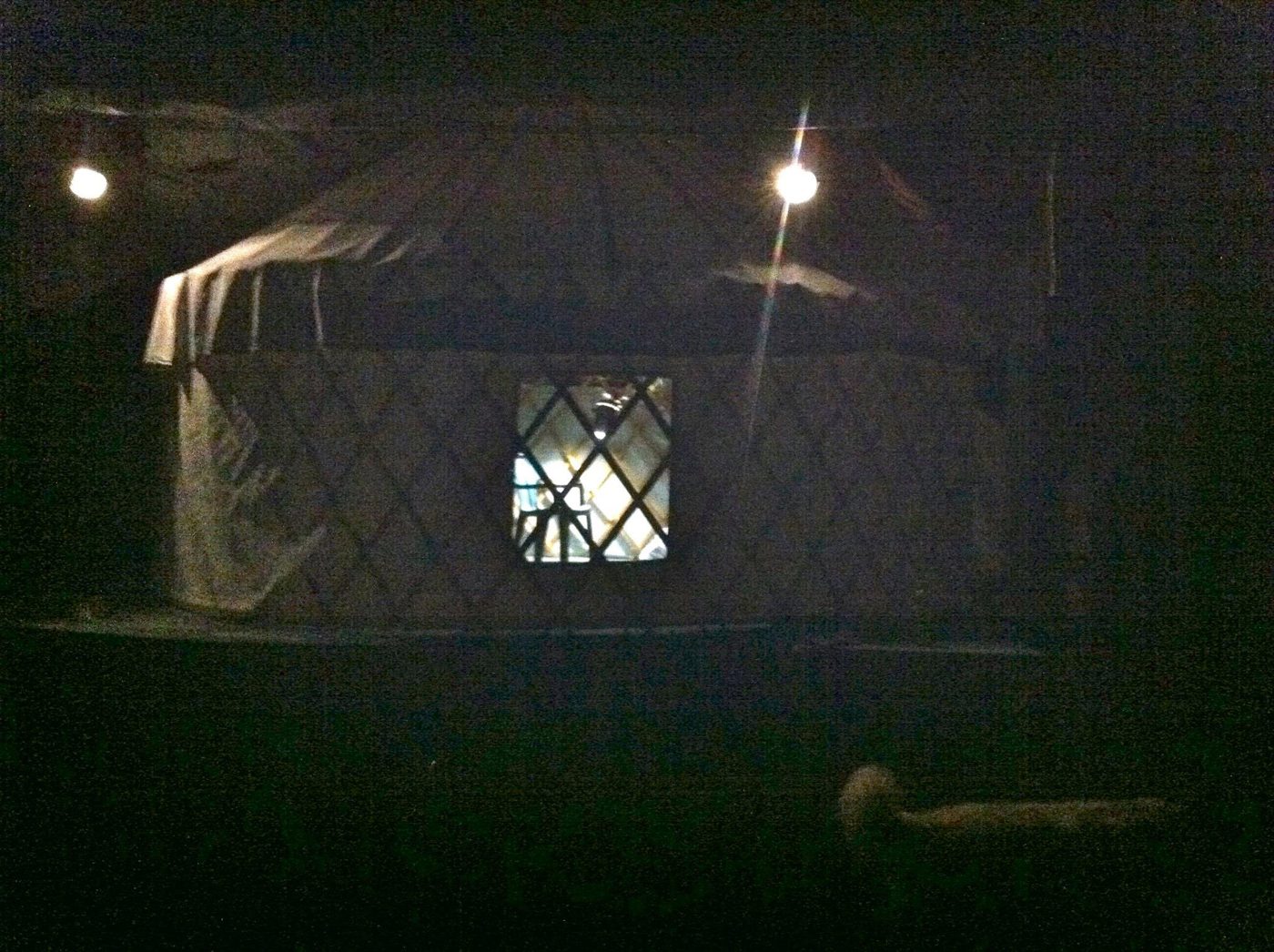 The yurt lit from inside.