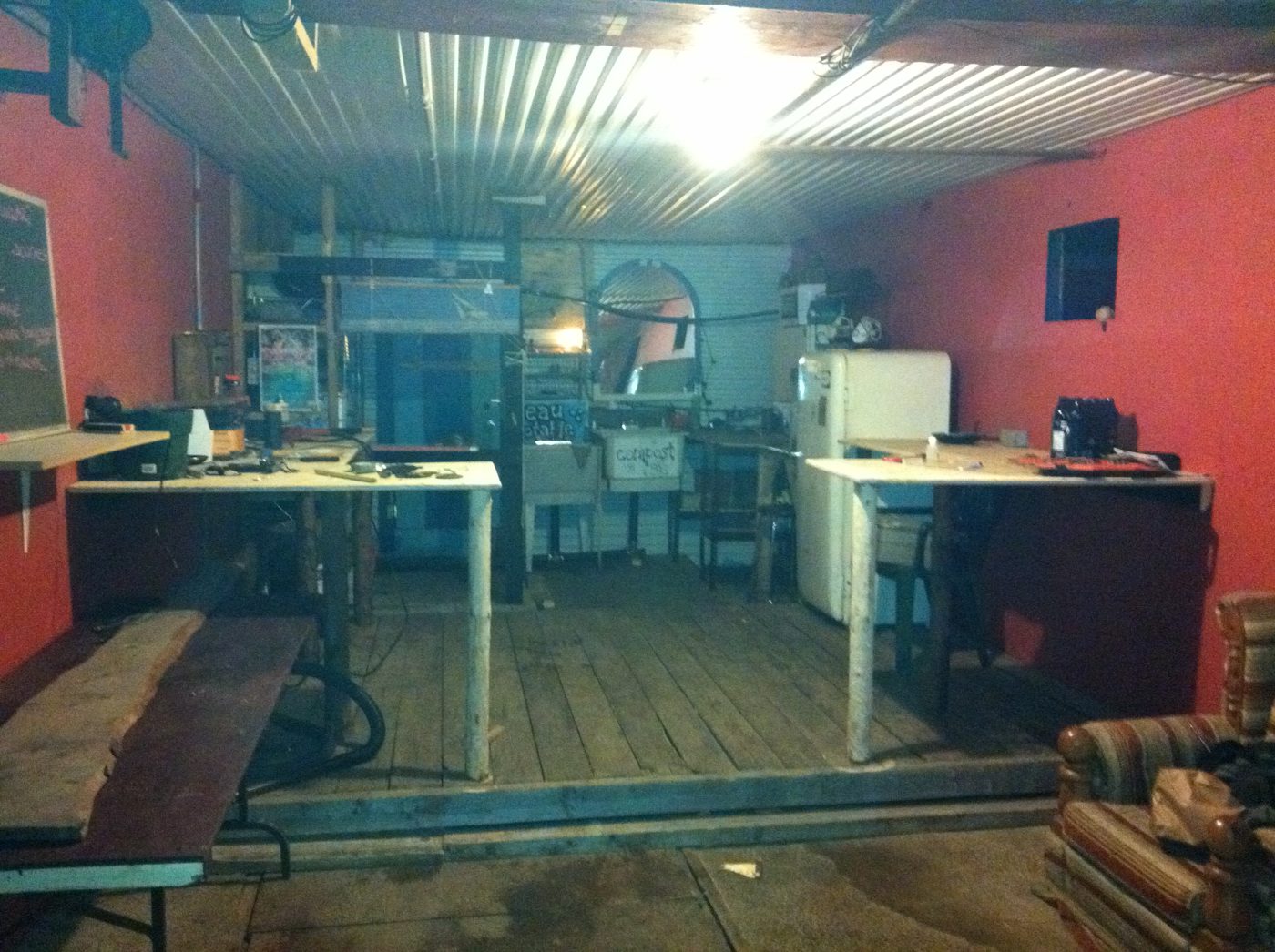 The bunker's kitchen, red walls and wooden floor.