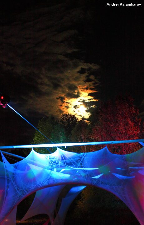 A canvas stretched over the stage, at night.
