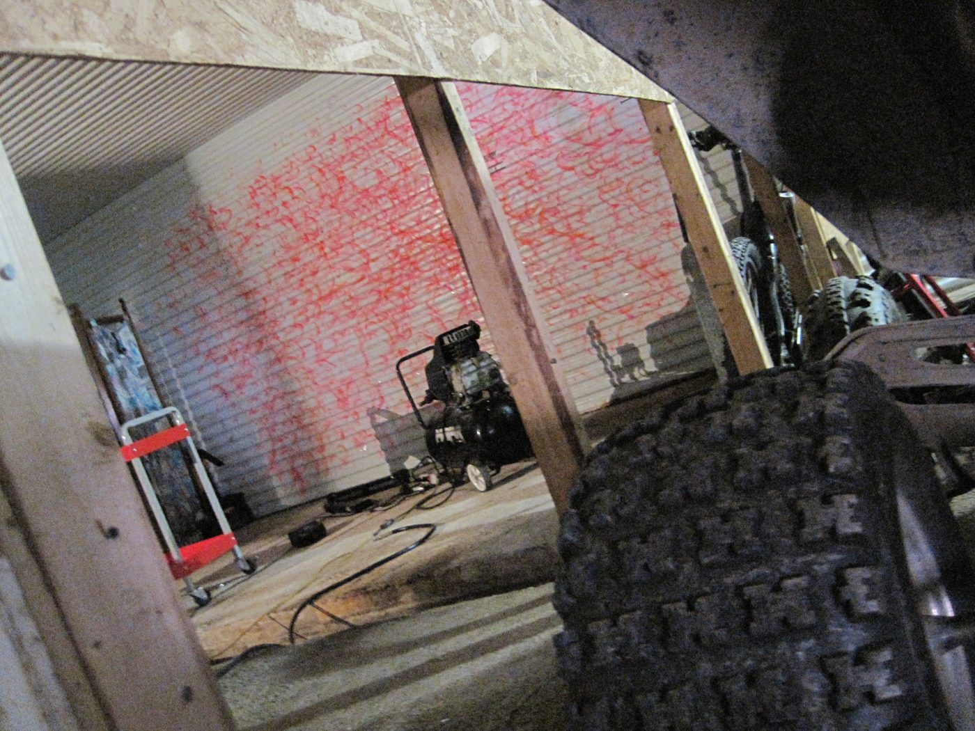 A wall painted red, a compressor, the dust.