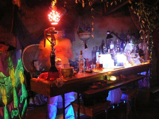 The Donjon's bed corner, under the purple lamp.
