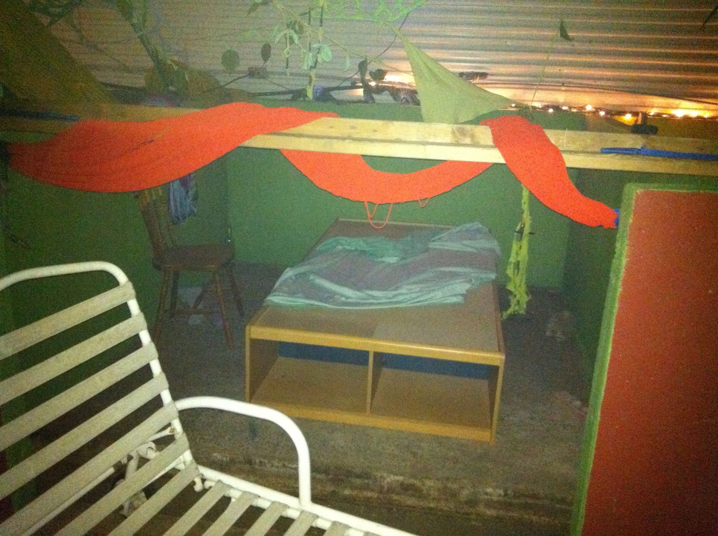 A bunker lodge turned into a bedroom, red fabrics, November 2011.
