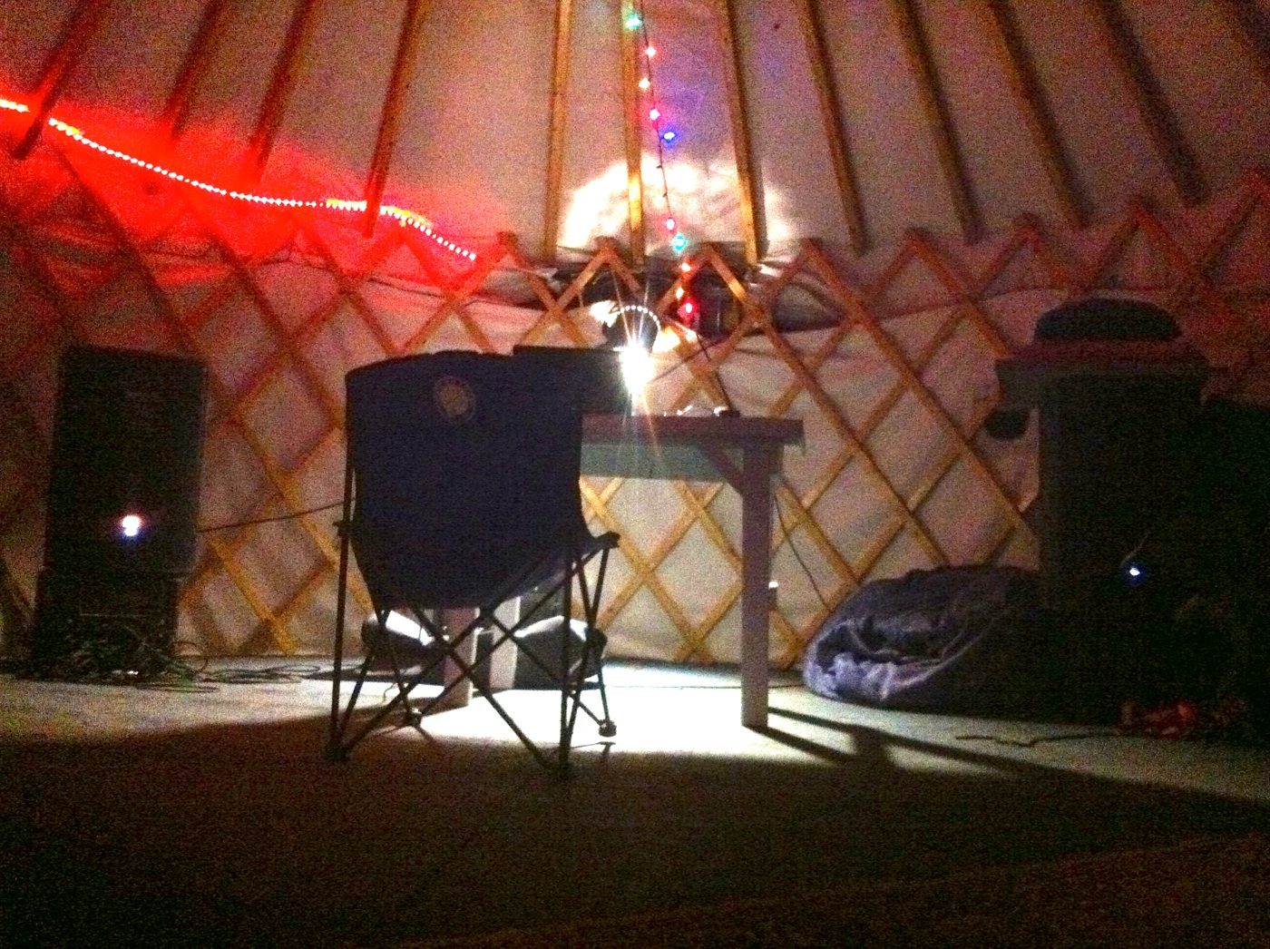 Inside the yurt, a chair and a lamp.